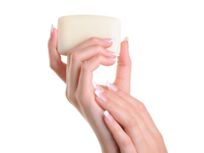 Beauty women hand holding the white soap - over white background